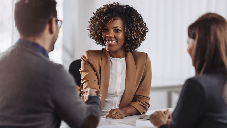 Business people shaking hands after successful meeting